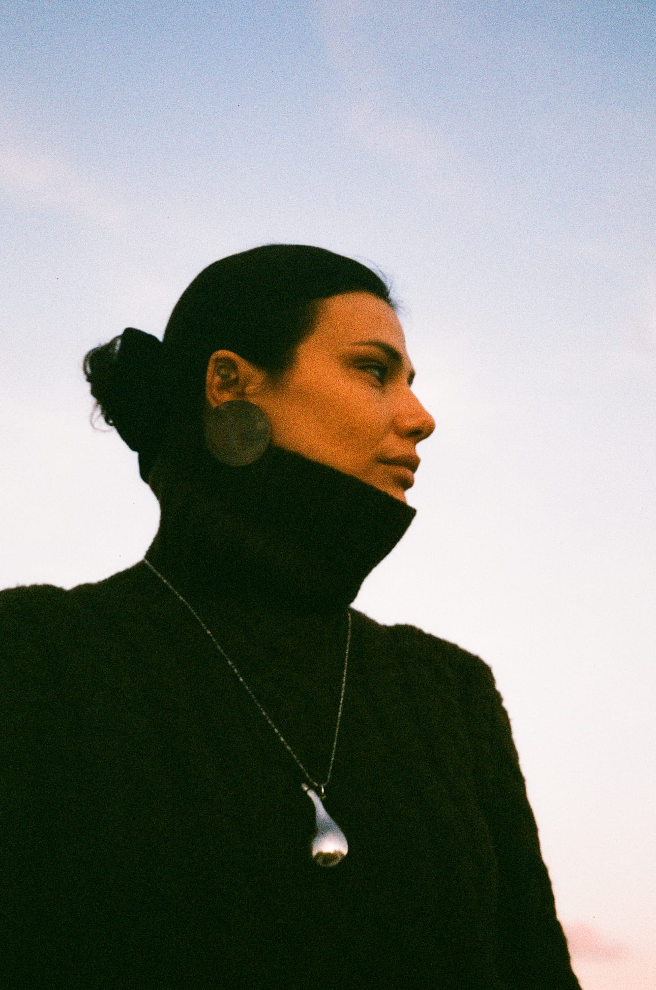 Profile portrait wearing a Mukani necklace at sunset.